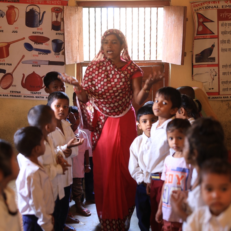 students being taught by a teacher at the Shree Janata Rashtriya Primary School in Bode Barsain Municipality in Saptari District in Nepal's southern plain. Credit: UNICEF/UNI448516/Laxmi-Prasad-Ngakhusi
